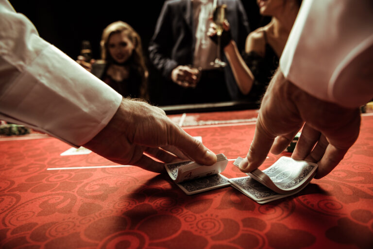 close up view of dealer shuffling cards in hands