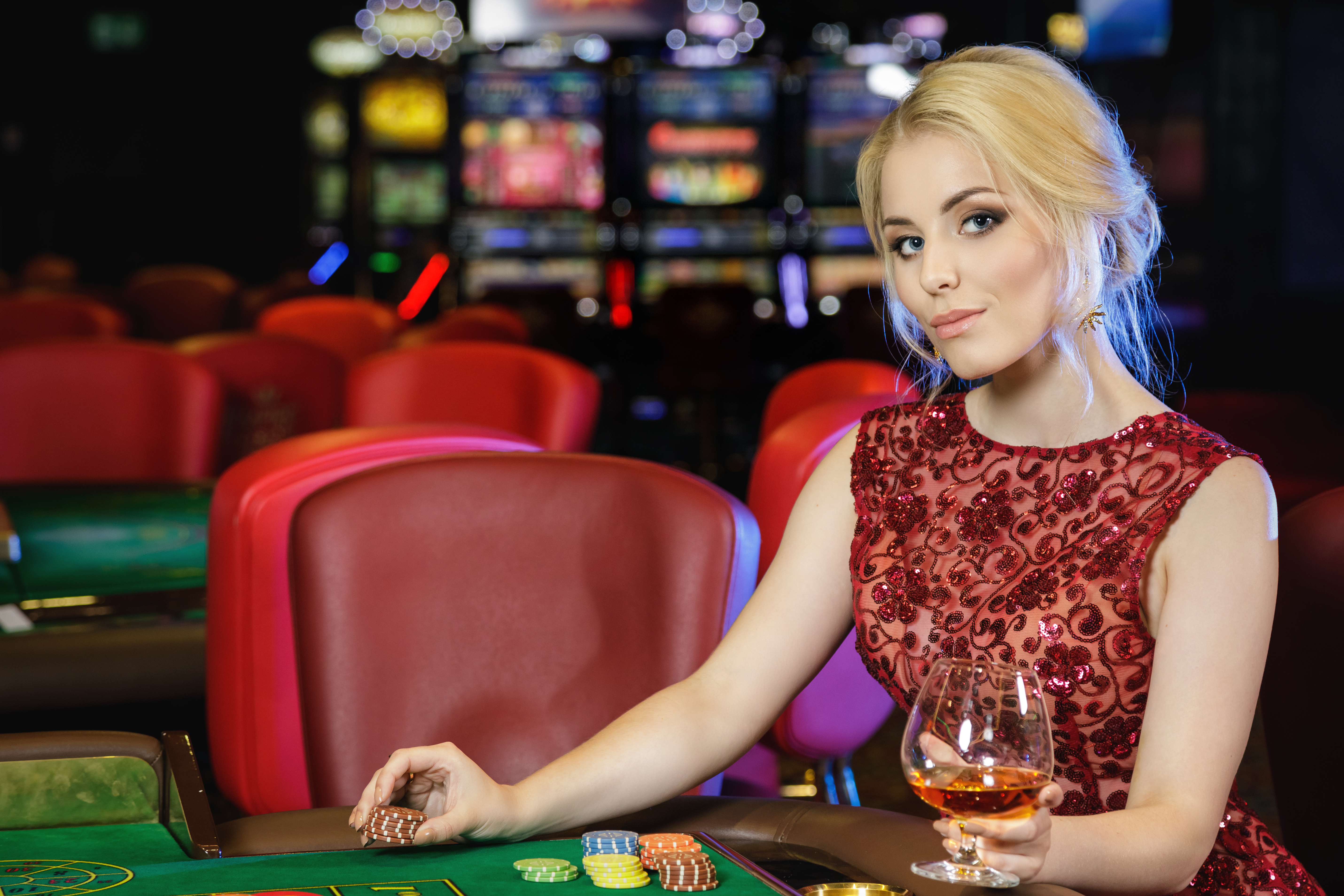 Young blonde woman playing roulette in the casino